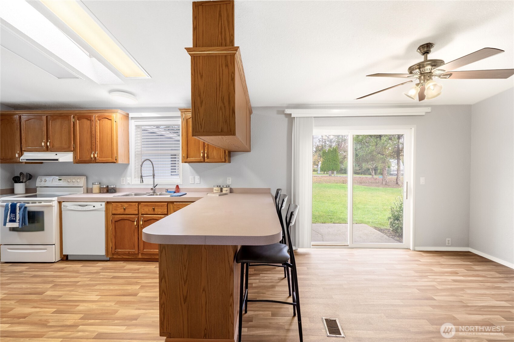 18000 Applegate Street Southwest Rochester, WA 98579 - Photo 13 of 40 a kitchen with a table chairs sink and cabinets