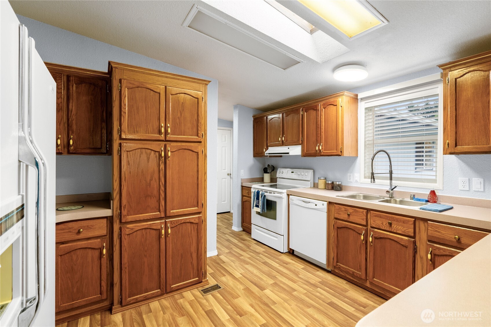 18000 Applegate Street Southwest Rochester, WA 98579 - Photo 14 of 40 a kitchen with stainless steel appliances granite countertop a refrigerator sink and wooden cabinets