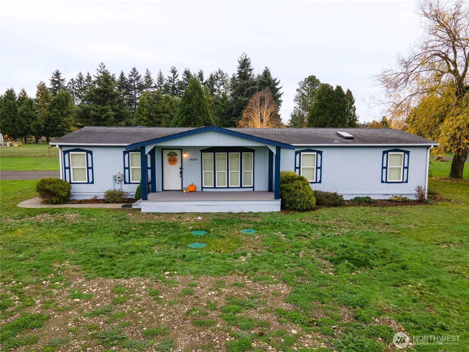 18000 Applegate Street Southwest Rochester, WA 98579 - Photo 2 of 40 a front view of a house with a garden and trees