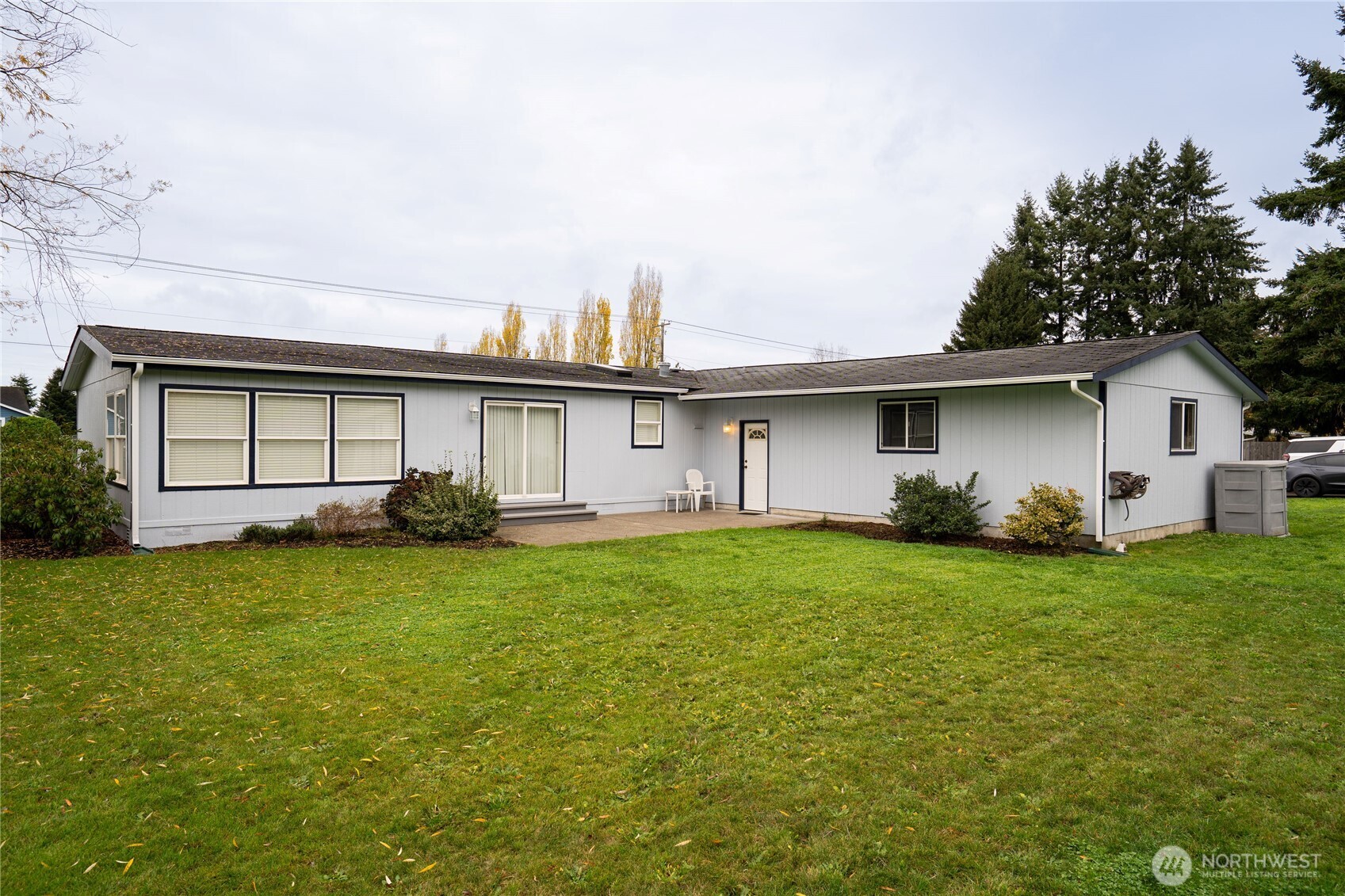 18000 Applegate Street Southwest Rochester, WA 98579 - Photo 33 of 40 a view of a yard in front of a house with plants and large tree