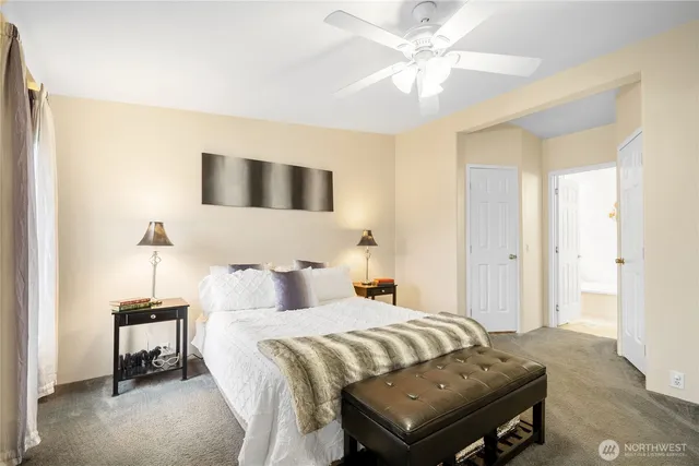 a bedroom with a bed and a chandelier