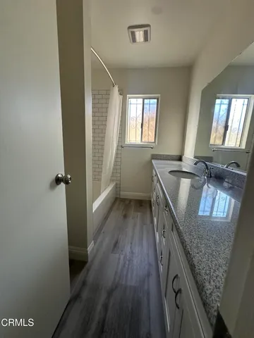 a kitchen with granite countertop a sink stove and refrigerator