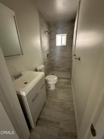 a bathroom with a sink a toilet and mirror