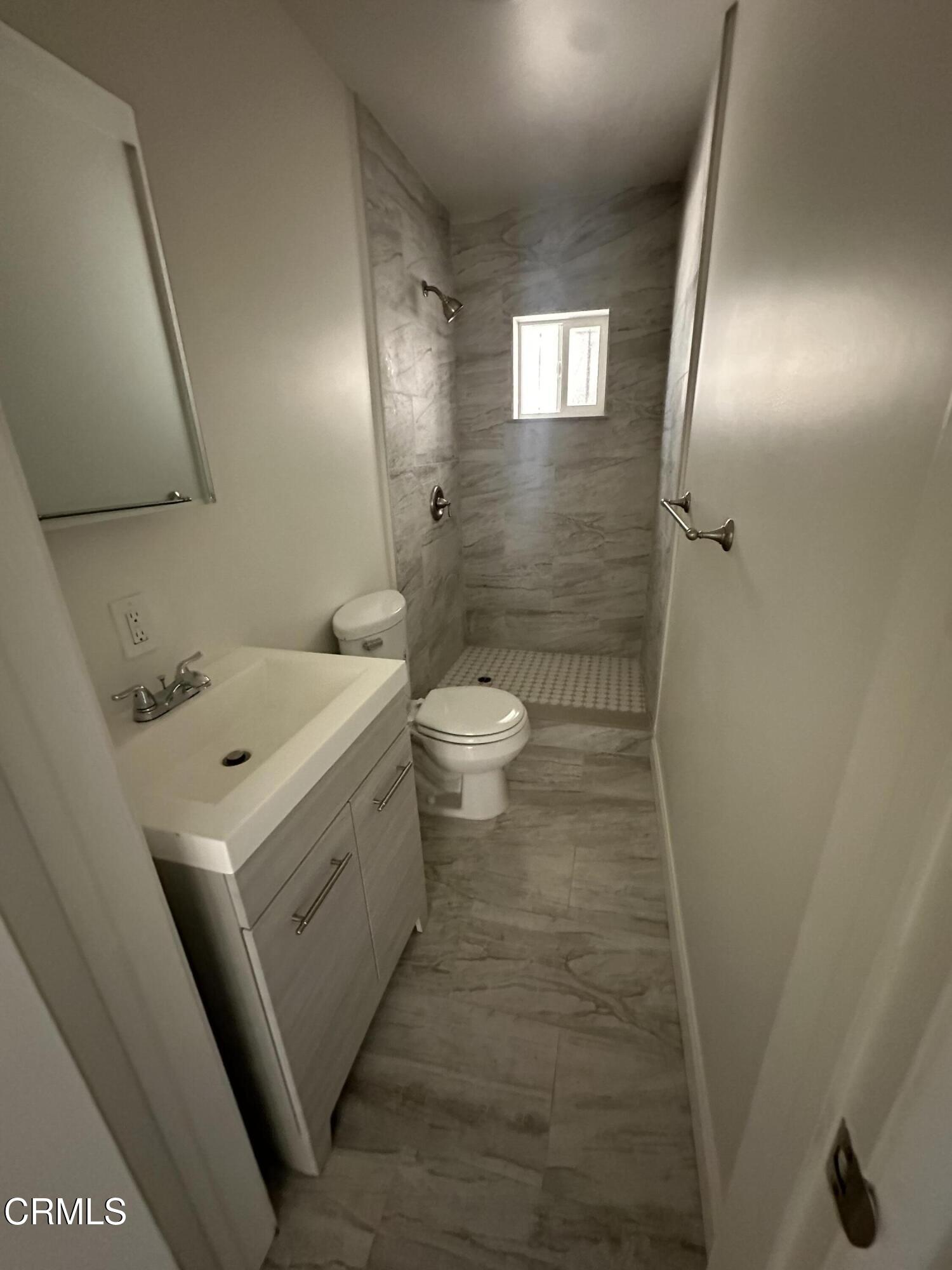 741 New Depot Street Los Angeles, CA 90012 - Photo 6 of 12 a bathroom with a sink a toilet and mirror