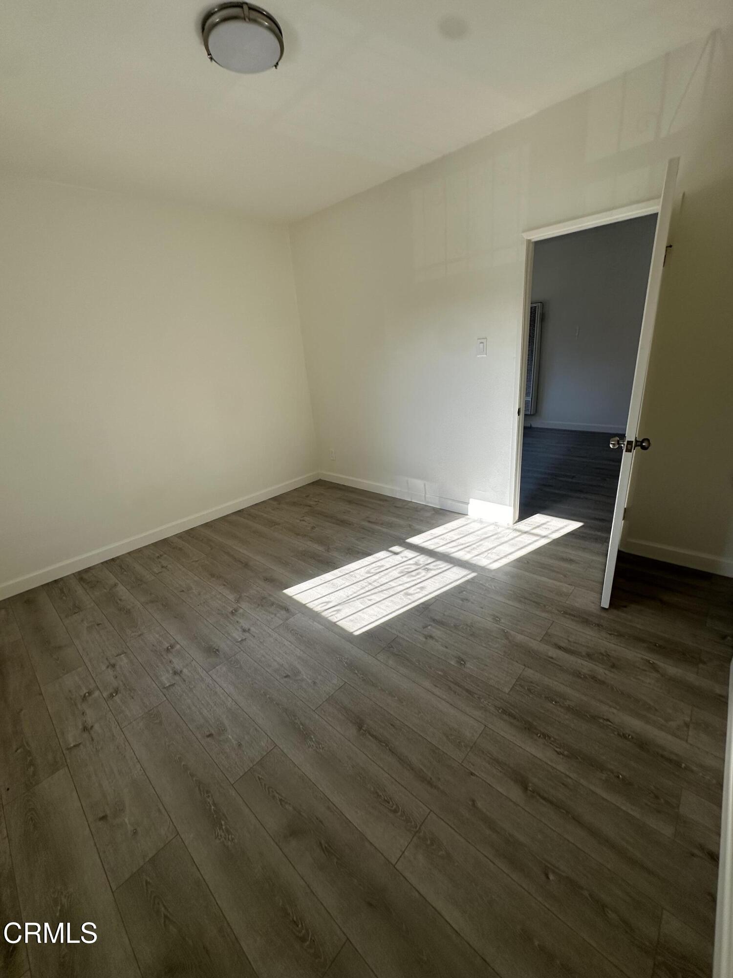741 New Depot Street Los Angeles, CA 90012 - Photo 10 of 12 a view of empty room with wooden floor