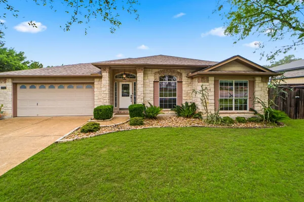 a front view of a house with a yard and garage