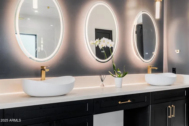 a bathroom with a double vanity sink a mirror and shower