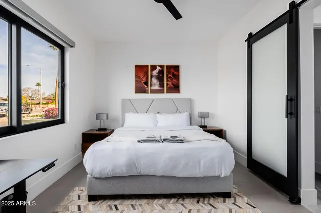 a bedroom with a bed and couch