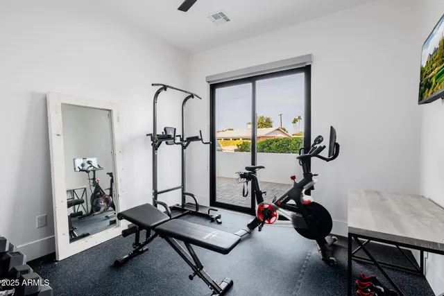 a roof deck with table and chairs under an umbrella