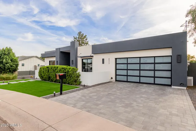 a view of a house with a yard and garage