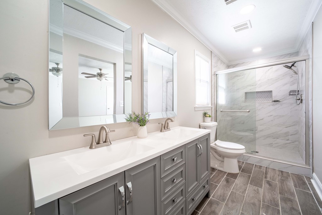 6308 Browning Drive Columbus, GA 31907 - Photo 15 of 19 a bathroom with a sink a toilet a mirror and shower