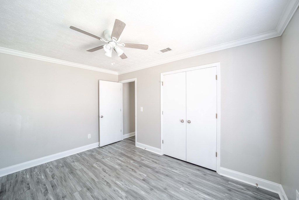 6308 Browning Drive Columbus, GA 31907 - Photo 17 of 19 an empty room with wooden floor ceiling fan and windows
