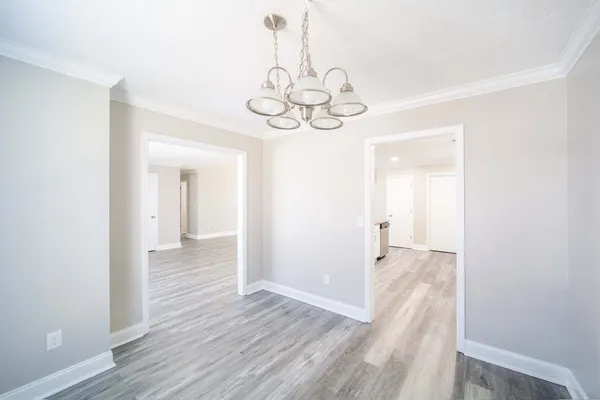 a large kitchen with granite countertop a sink and a refrigerator