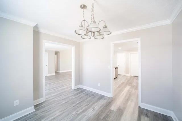 a large kitchen with granite countertop a sink and a refrigerator