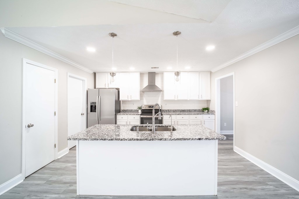 6308 Browning Drive Columbus, GA 31907 - Photo 5 of 19 a large kitchen with granite countertop a sink and a refrigerator