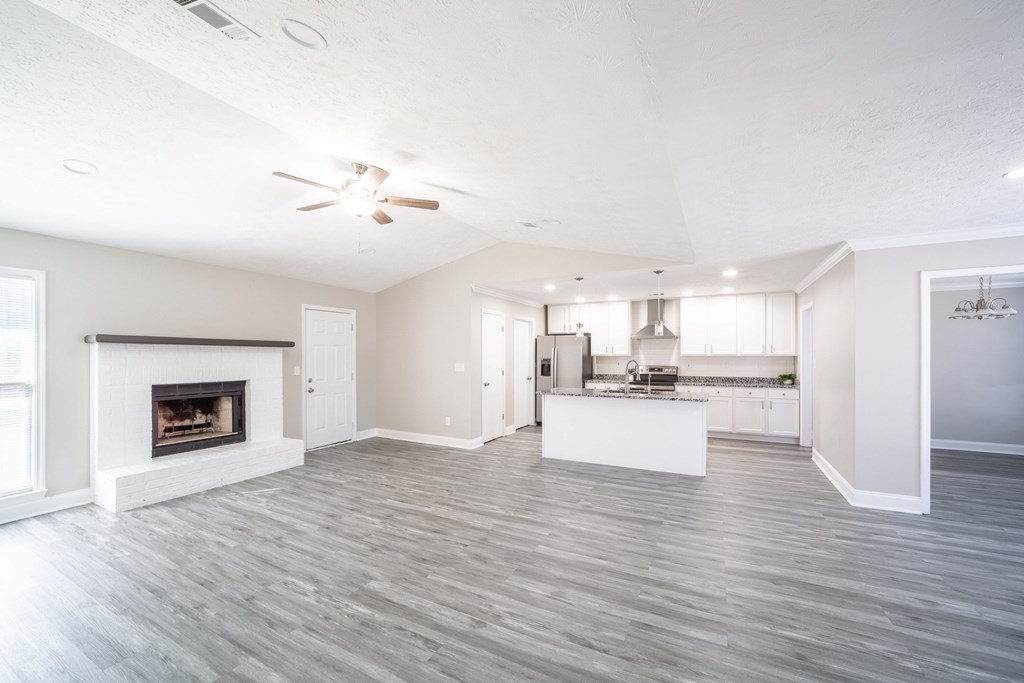 6308 Browning Drive Columbus, GA 31907 - Photo 7 of 19 a view of a kitchen and an empty room with a fireplace