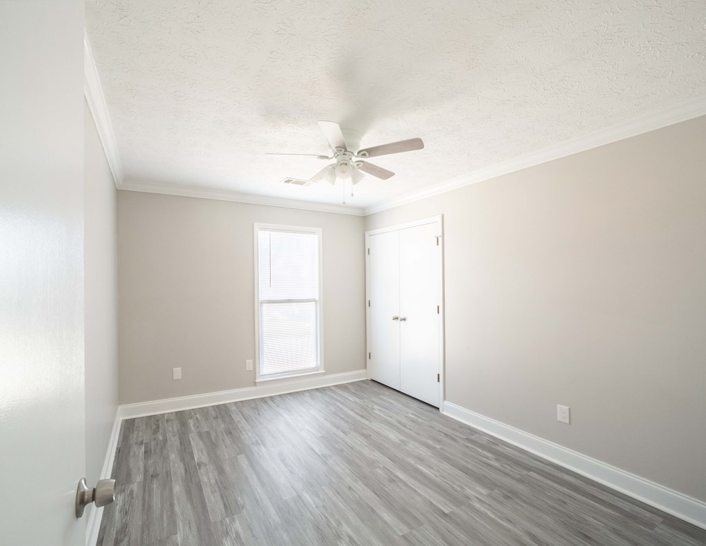 6308 Browning Drive Columbus, GA 31907 - Photo 10 of 19 an empty room with wooden floor and ceiling fan