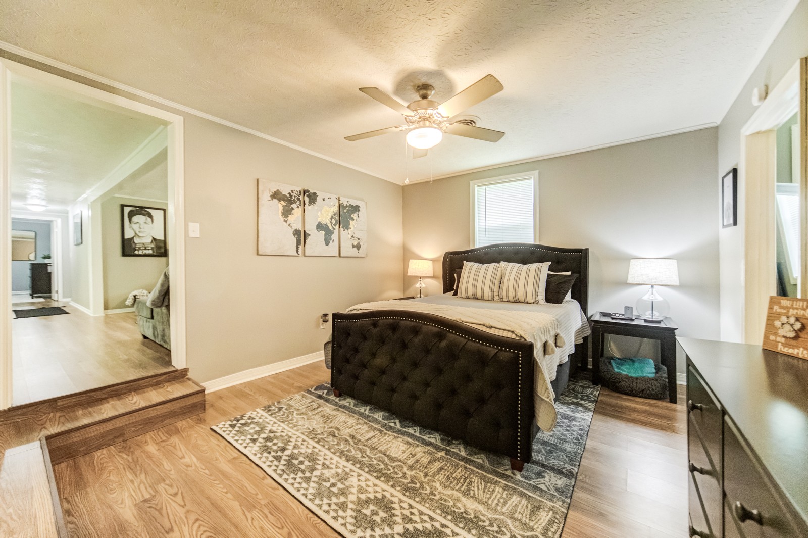 325 Denning Ford Road Portland, TN 37148 - Photo 17 of 35 a bedroom with a large bed and a chandelier