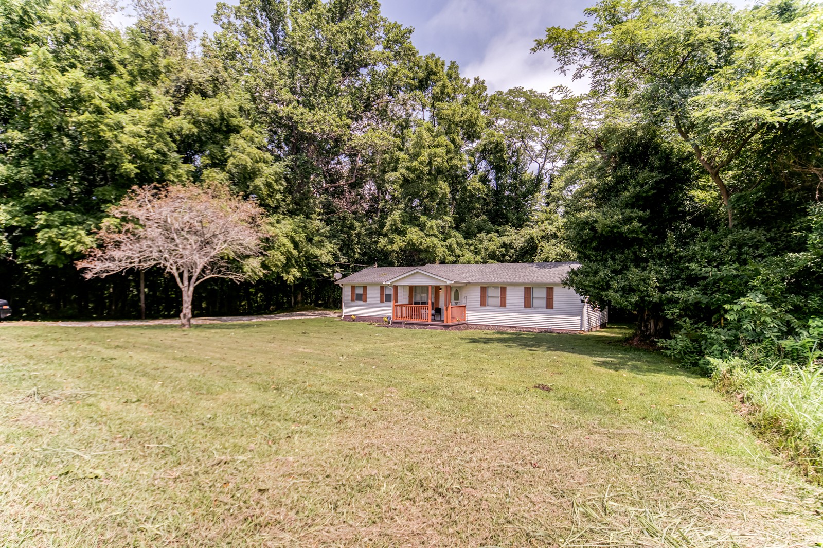 325 Denning Ford Road Portland, TN 37148 - Photo 2 of 35 a house with trees in front of it