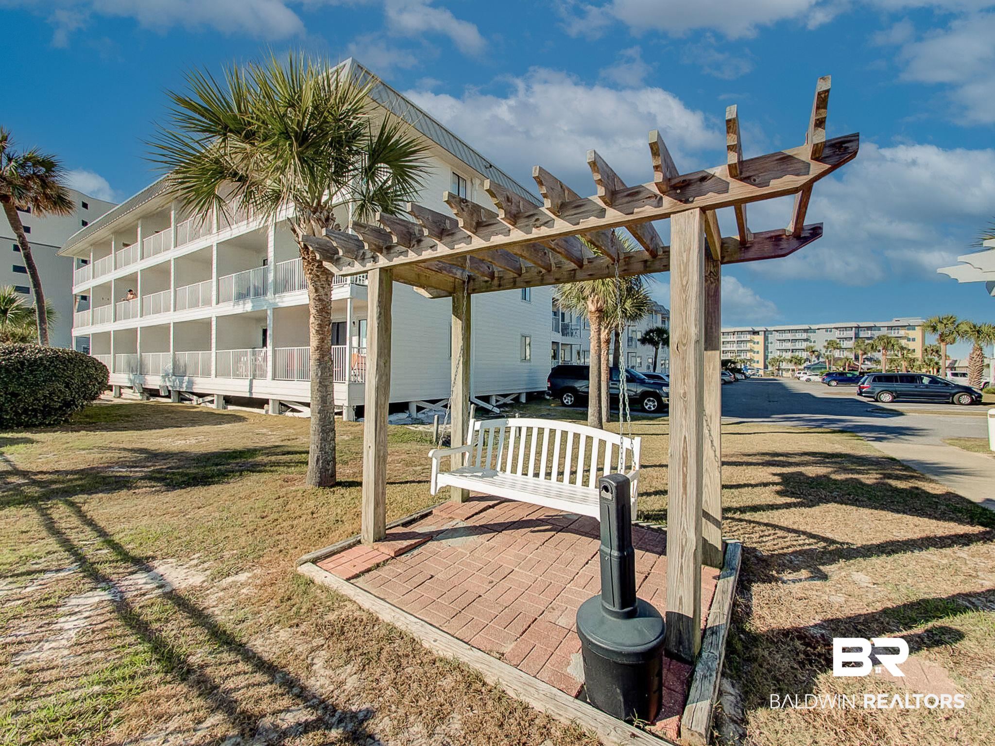 400 Plantation Road, Unit 4115 Gulf Shores, AL 36542 - Photo 39 of 48 Exterior space featuring a pergola and a lawn