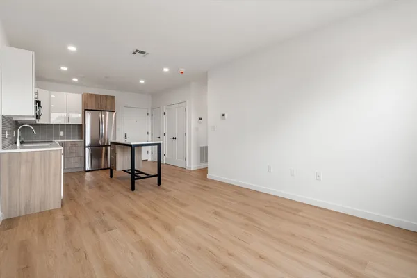 a view of kitchen with cabinets and wooden floor
