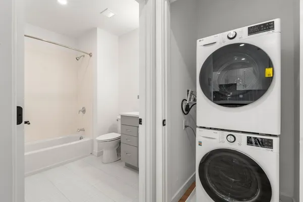 a view of a bathroom with washing machine and a view of bathroom