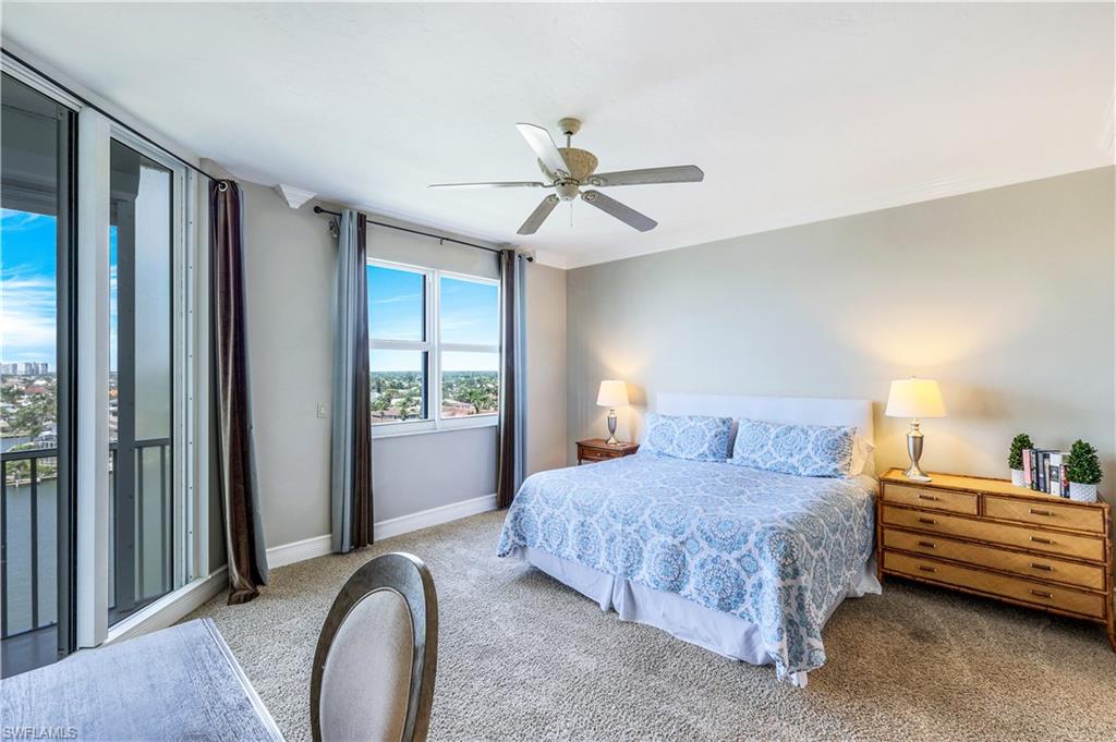 410 Flagship Drive, Unit 903 Naples, FL 34108 - Photo 15 of 29 a bedroom with a bed couch and a window