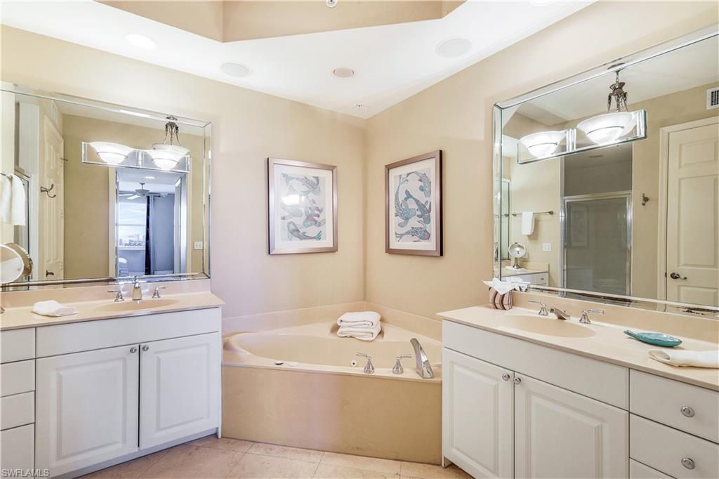 410 Flagship Drive, Unit 903 Naples, FL 34108 - Photo 16 of 29 a spacious bathroom with a double vanity sink mirror double and bathtub