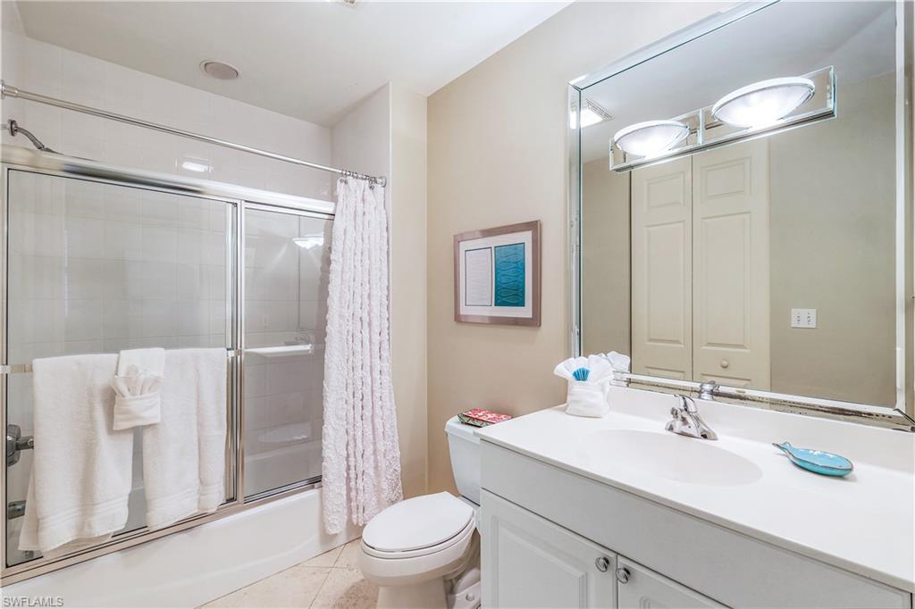 410 Flagship Drive, Unit 903 Naples, FL 34108 - Photo 18 of 29 a bathroom with a sink toilet and shower