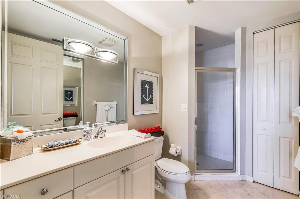 410 Flagship Drive, Unit 903 Naples, FL 34108 - Photo 20 of 29 a bathroom with a sink vanity granite and toilet