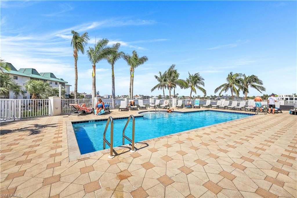 410 Flagship Drive, Unit 903 Naples, FL 34108 - Photo 27 of 29 a view of swimming pool with outdoor seating