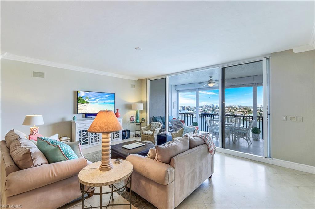 410 Flagship Drive, Unit 903 Naples, FL 34108 - Photo 5 of 29 a living room with furniture and a large window
