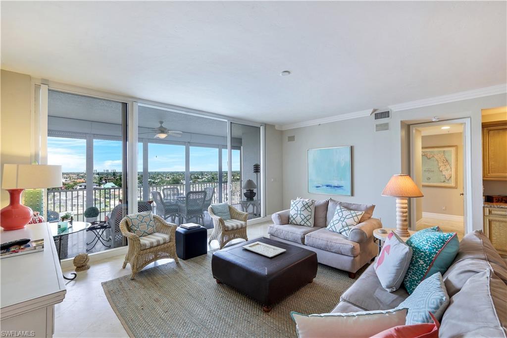 410 Flagship Drive, Unit 903 Naples, FL 34108 - Photo 7 of 29 a living room with furniture and a floor to ceiling window