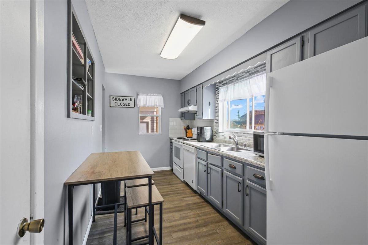 8 University Court Normal, IL 61761 - Photo 5 of 19 a kitchen with stainless steel appliances granite countertop a refrigerator a stove a sink dishwasher and white cabinets with wooden floor