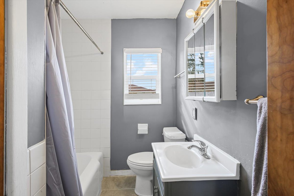 8 University Court Normal, IL 61761 - Photo 8 of 19 a bathroom with a sink a toilet and a mirror