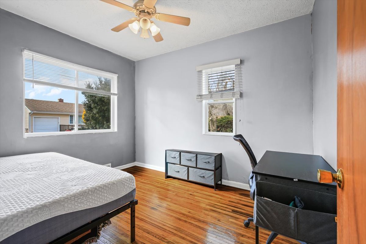8 University Court Normal, IL 61761 - Photo 9 of 19 a bedroom with a bed windows and wooden floor