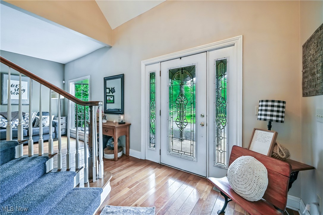 1681 State Road Northwest Warren, OH 44481 - Photo 19 of 50 Entryway with stairs, leaded glass front door and side panels, wood floors and high vaulted ceiling