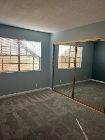 an empty room with a empty space and windows