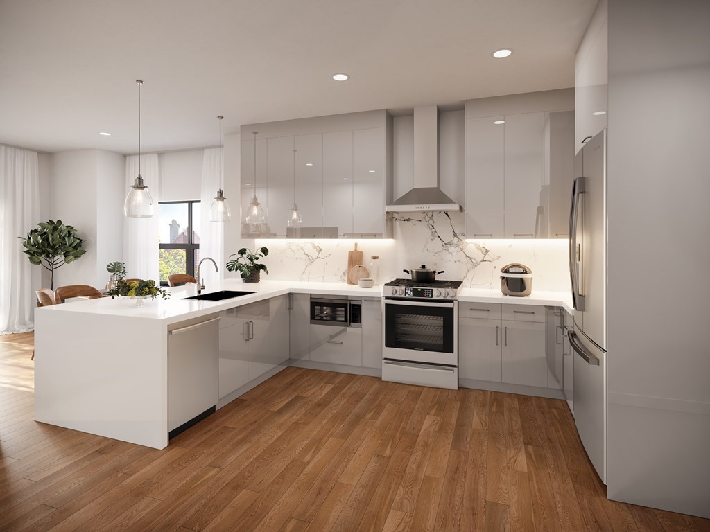 44 Cottage Street, Unit 1 Boston, MA 02128 - Photo 6 of 10 a kitchen with white cabinets stainless steel appliances and wooden floor