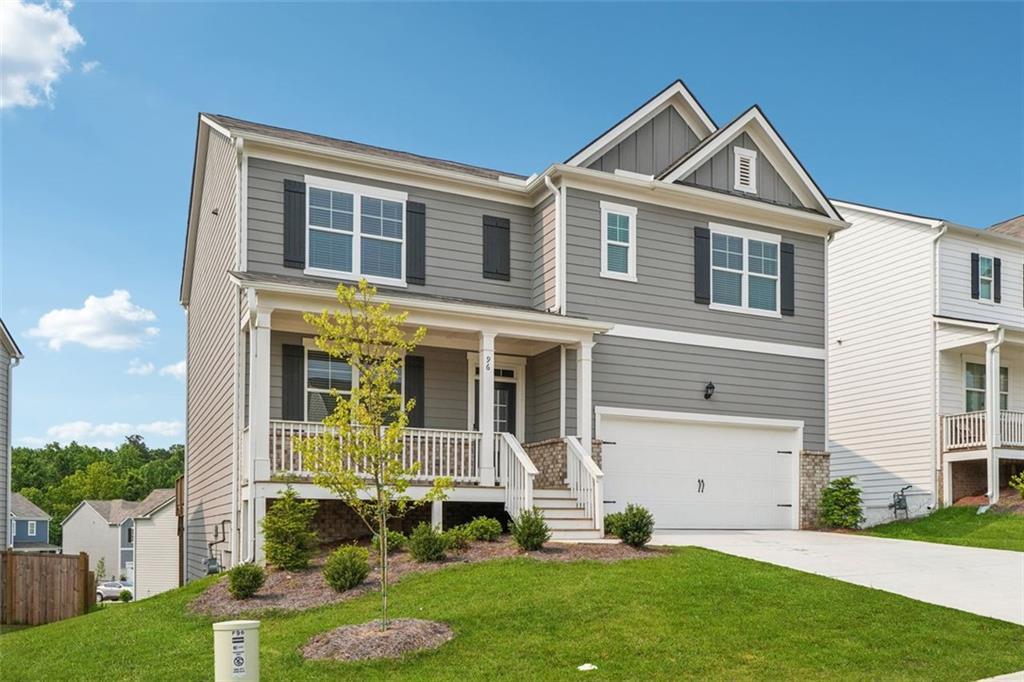 a front view of a house with a yard and porch