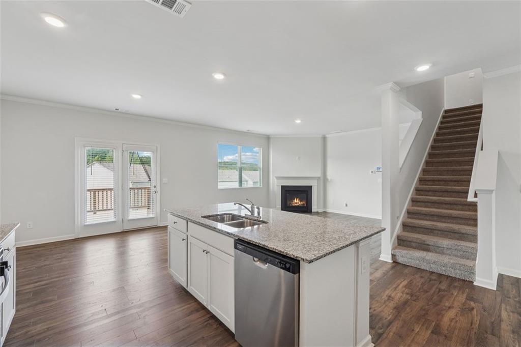 96 Quail Bend Way Dallas, GA 30157 - Photo 11 of 58 a open kitchen with white cabinets and wooden floor
