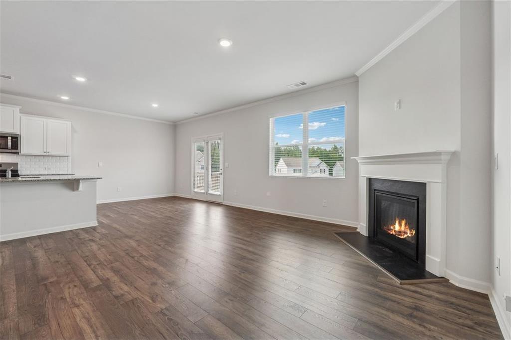 96 Quail Bend Way Dallas, GA 30157 - Photo 14 of 58 a view of an empty room with wooden floor and a fireplace