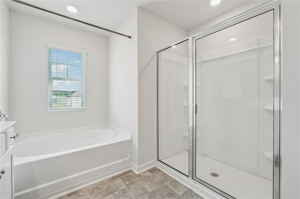 96 Quail Bend Way Dallas, GA 30157 - Photo 21 of 58 a bathroom with a bathtub and a shower