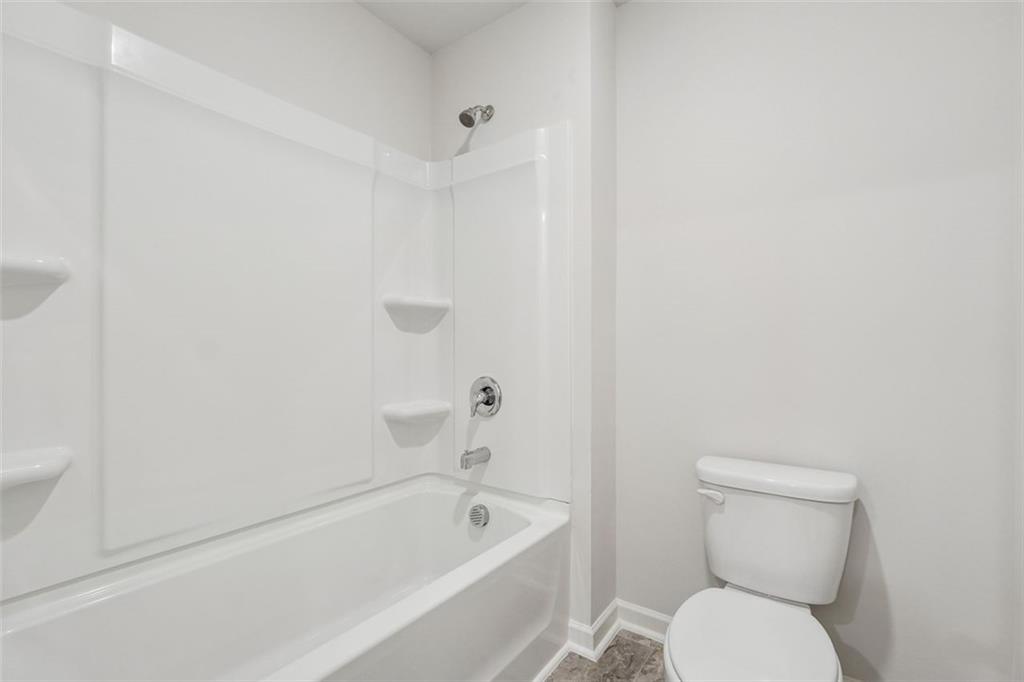 96 Quail Bend Way Dallas, GA 30157 - Photo 31 of 58 a white toilet sitting next to a bath tub