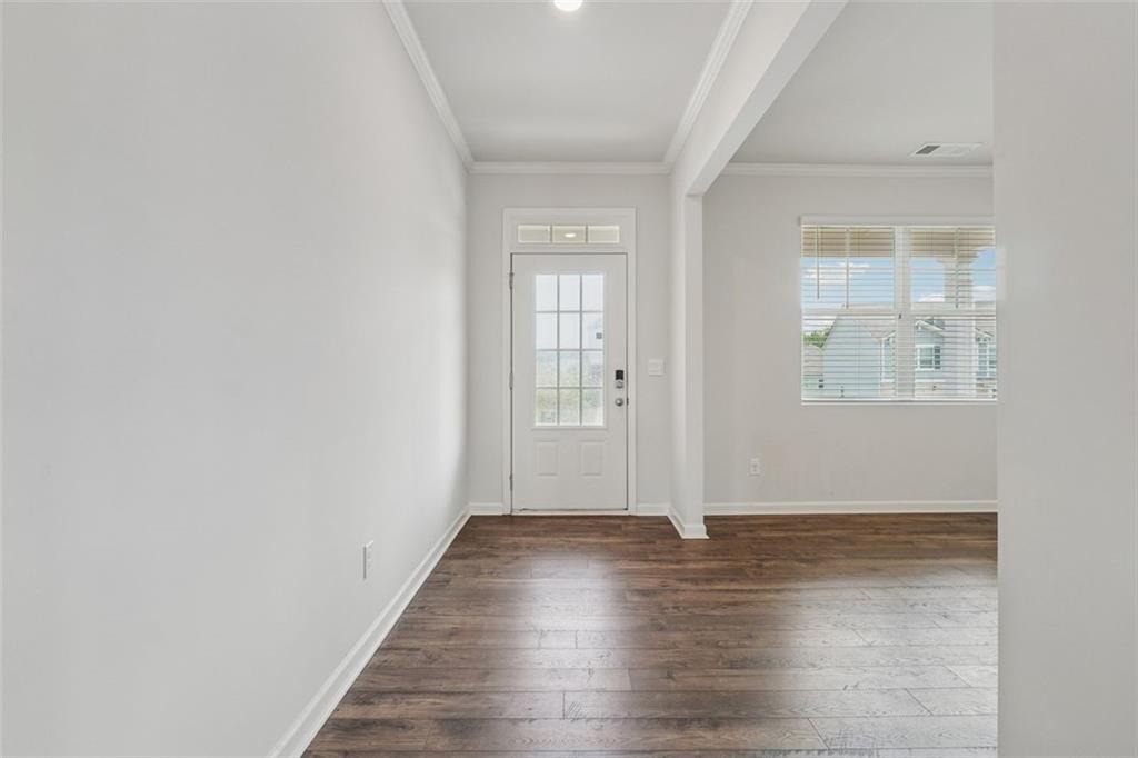 96 Quail Bend Way Dallas, GA 30157 - Photo 5 of 58 an empty room with wooden floor and windows