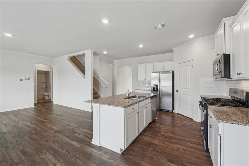96 Quail Bend Way Dallas, GA 30157 - Photo 8 of 58 a kitchen with stainless steel appliances granite countertop a stove top oven a sink and a refrigerator