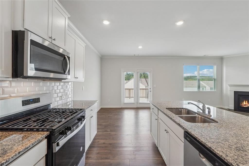 96 Quail Bend Way Dallas, GA 30157 - Photo 10 of 58 a kitchen with granite countertop stainless steel appliances a stove microwave and sink
