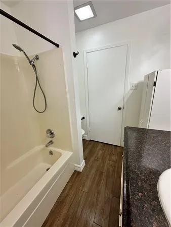 a bathroom with a bathtub and a shower