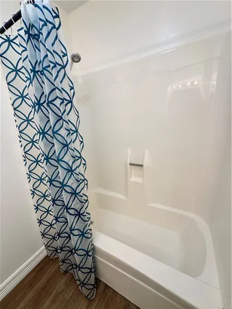 a bathroom with a bathtub and shower
