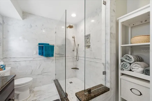 a bathroom with a shower a toilet and sink